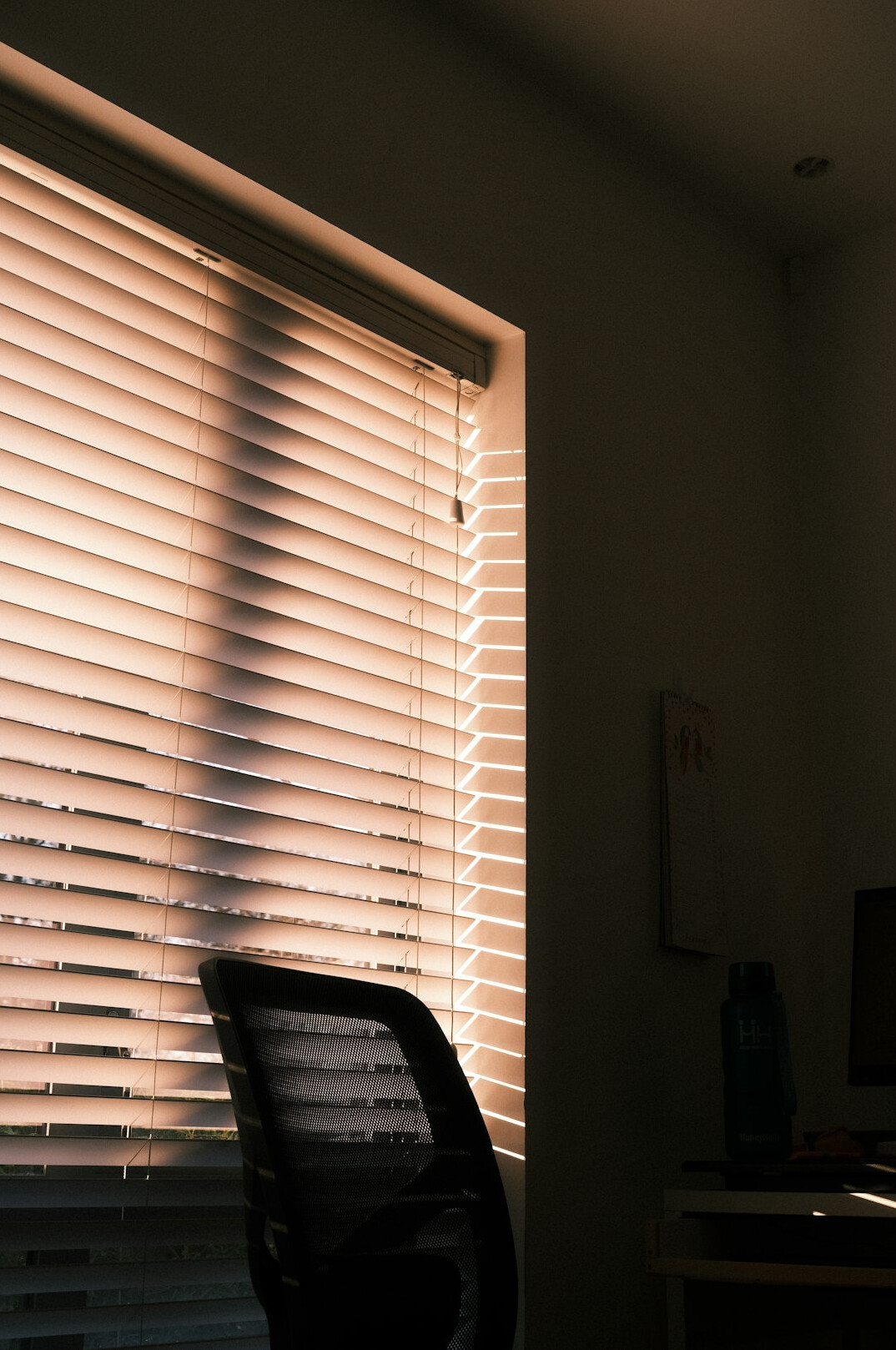Quiet minimalist office interior with large window and soft light